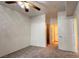 Bedroom featuring neutral carpet, a ceiling fan, and access to the closet, providing a private retreat at 7163 S Durango Dr # 113, Las Vegas, NV 89113