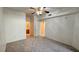 Comfortable bedroom with neutral carpet, a ceiling fan, and access to the bathroom, providing a relaxing retreat at 7163 S Durango Dr # 113, Las Vegas, NV 89113