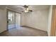 Spacious bedroom featuring neutral carpet and a sliding glass door, offering access to the outside patio area at 7163 S Durango Dr # 113, Las Vegas, NV 89113