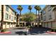 Exterior of building with multiple garage doors, palm trees, and grass areas at 7163 S Durango Dr # 113, Las Vegas, NV 89113
