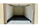 Interior of garage featuring painted concrete, and door to unit at 7163 S Durango Dr # 113, Las Vegas, NV 89113