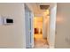 Hallway view leading to bathroom with tiled floors and brown wood vanity at 7163 S Durango Dr # 113, Las Vegas, NV 89113