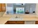 Kitchen with a breakfast bar overlooking the living room with lots of light and stainless steel dishwasher at 7163 S Durango Dr # 113, Las Vegas, NV 89113