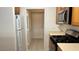 Well-equipped kitchen with stainless steel appliances and plenty of storage space, adjacent to the hallway and laundry area at 7163 S Durango Dr # 113, Las Vegas, NV 89113
