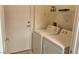 Convenient laundry area with a washer and dryer, plus additional shelving for storage and a nearby door at 7163 S Durango Dr # 113, Las Vegas, NV 89113