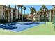 Well-maintained tennis court surrounded by green landscaping and nearby apartment buildings at 7163 S Durango Dr # 113, Las Vegas, NV 89113