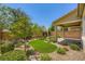 Landscaped backyard featuring desert landscaping, brick pavers and artificial turf at 8048 Skye Bridge St, Las Vegas, NV 89166