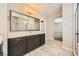 Modern bathroom featuring a large mirror, elegant vanity, and a glass-enclosed shower at 8048 Skye Bridge St, Las Vegas, NV 89166
