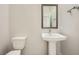 Elegant half bathroom with modern fixtures, a pedestal sink, and a decorative wall at 8048 Skye Bridge St, Las Vegas, NV 89166