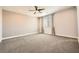 Spacious bedroom with neutral walls, plush carpeting, and natural light from a window at 8048 Skye Bridge St, Las Vegas, NV 89166