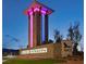 Community entrance monument with stone accents and colorful lighting at dusk at 8048 Skye Bridge St, Las Vegas, NV 89166