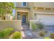 Welcoming front entrance with stone walkway, desert landscaping, and a quaint courtyard at 8048 Skye Bridge St, Las Vegas, NV 89166