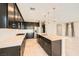 Modern kitchen with dark cabinets, white countertops, and an island with pendant lighting at 8048 Skye Bridge St, Las Vegas, NV 89166