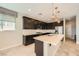 Well-lit kitchen featuring modern appliances, stylish dark cabinetry, and a center island at 8048 Skye Bridge St, Las Vegas, NV 89166