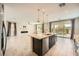 Open-concept kitchen features an island with quartz countertops and stainless steel appliances at 8048 Skye Bridge St, Las Vegas, NV 89166