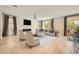 Spacious living room with modern furnishings, a fireplace, and large windows at 8048 Skye Bridge St, Las Vegas, NV 89166