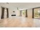 Bright, open living room featuring a modern fireplace, tile flooring, and ample natural light at 8048 Skye Bridge St, Las Vegas, NV 89166