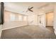 Upstairs living room with neutral walls, plush carpeting, and natural light from a window at 8048 Skye Bridge St, Las Vegas, NV 89166