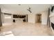 Spacious open-concept living area with tile floors flowing into the modern kitchen at 8048 Skye Bridge St, Las Vegas, NV 89166