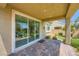 Covered patio with brick pavers, sliding glass door and manicured landscaping at 8048 Skye Bridge St, Las Vegas, NV 89166