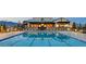 Community pool with lounge chairs and manicured landscaping with mountain views at 8048 Skye Bridge St, Las Vegas, NV 89166