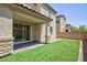 Backyard with artificial turf, a privacy wall, and a covered patio at 835 Aurelie Ridge St, Henderson, NV 89011