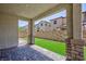 A covered patio that looks out over a low maintenance backyard with artificial turf at 835 Aurelie Ridge St, Henderson, NV 89011