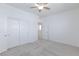 Neutral bedroom features carpet flooring, a ceiling fan, closet, and a door leading to another room at 835 Aurelie Ridge St, Henderson, NV 89011