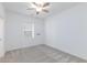 Bedroom features neutral carpet, ceiling fan, and a window letting in natural light at 835 Aurelie Ridge St, Henderson, NV 89011