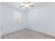 Bright bedroom features neutral carpet, a ceiling fan, and a window letting in natural light at 835 Aurelie Ridge St, Henderson, NV 89011