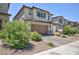 Two story home with tan and brown paint, low maintenance landscaping at 835 Aurelie Ridge St, Henderson, NV 89011