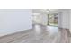 Bright living room features wood floors and sliding glass doors to the backyard at 835 Aurelie Ridge St, Henderson, NV 89011