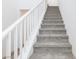 Carpeted staircase features white risers and neutral colored walls at 835 Aurelie Ridge St, Henderson, NV 89011
