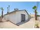 The backyard features a patio and secured door with desert-friendly landscaping at 882 Westminster Ave, Las Vegas, NV 89119