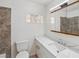 Bathroom featuring stylish vanity, tiled shower, glass block window for natural light at 882 Westminster Ave, Las Vegas, NV 89119