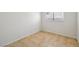 This bedroom has neutral tile floors and a window providing natural light, making it warm and inviting at 882 Westminster Ave, Las Vegas, NV 89119