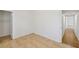 An empty bedroom showcasing neutral tile floors, freshly painted walls and hallway access at 882 Westminster Ave, Las Vegas, NV 89119