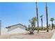 Home exterior featuring desert landscaping and mature palm trees, creating a serene setting at 882 Westminster Ave, Las Vegas, NV 89119