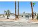 Quaint single-story home with mature palm trees, xeriscaping, and a front driveway with garage at 882 Westminster Ave, Las Vegas, NV 89119