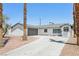Charming single-story home featuring a gray garage door, well-maintained landscaping, and a welcoming driveway at 882 Westminster Ave, Las Vegas, NV 89119