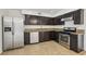The kitchen is equipped with stainless steel appliances, granite countertops and dark wood cabinets at 882 Westminster Ave, Las Vegas, NV 89119