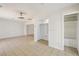 Bright living room with tile floors, modern ceiling fan, and access to storage and other rooms at 882 Westminster Ave, Las Vegas, NV 89119