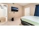 Cozy bedroom featuring a mounted TV, a neutral color scheme and a comfortable mattress at 9330 W Maule Ave # 138, Las Vegas, NV 89148