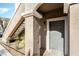 Close-up of an apartment entrance featuring a neutral-colored door and adjacent staircase at 9330 W Maule Ave # 138, Las Vegas, NV 89148
