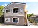 Two-story condo building with neutral paint, white trim, and stair access to upper units at 9330 W Maule Ave # 138, Las Vegas, NV 89148