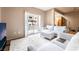 Bright living room featuring a plush rug and white furniture with access to a balcony at 9330 W Maule Ave # 138, Las Vegas, NV 89148