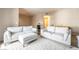 Open living room with white sofas, plush rug, and neutral walls and trim at 9330 W Maule Ave # 138, Las Vegas, NV 89148