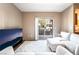 Bright living room featuring a plush rug and white furniture with access to a balcony at 9330 W Maule Ave # 138, Las Vegas, NV 89148