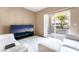 Cozy living room with plush white furniture and a sliding glass door to the outside at 9330 W Maule Ave # 138, Las Vegas, NV 89148