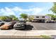 Apartment parking lot showcasing parked cars and the building's exterior under a bright blue sky at 9330 W Maule Ave # 138, Las Vegas, NV 89148